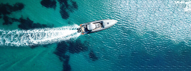 Aerial drone ultra wide photo of luxury inflatable speed boat cruising deep blue Aegean sea, Greece