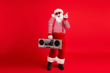 Poster - Full length body size view of his he nice handsome cheerful cheery comic childish Santa father having fun celebratory festive listening stereo isolated bright vivid shine vibrant red color background