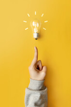 The Emergence Of A New Creative Idea. A Glowing Light Bulb Is A Symbol Of A Brilliant Idea