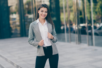 Photo of joyful pretty attractive business woman wear formalwear suit pants outdoors in city center
