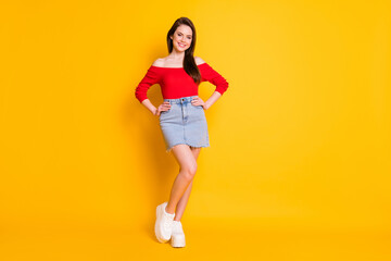 Wall Mural - Full length body size view of her she nice attractive lovable gorgeous content cheerful girl posing hands on hips isolated over bright vivid shine vibrant yellow color background