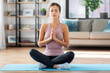 © Syda Productions - yoga, sport and healthy lifestyle concept - woman meditating in lotus pose at home