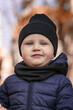 © Maryana - Portrait of a little boy in a black hat and blue jacket. Baby in warm clothes close up