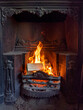 Open wood and coal fire in a Victorian cast iron fireplace