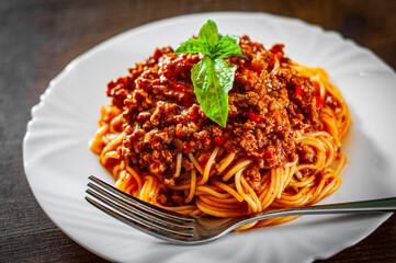 Wall Mural - Traditional pasta spaghetti bolognese in white plate on wooden table background