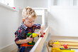 © Mint Images - Young boy using toy power tool at home