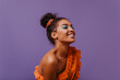 © Look! - Blissful black woman in summer dress laughing on violet background. Adorable african girl in orange outfit posing with happy face expression.