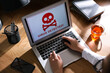 Leinwandbild Motiv Woman using laptop with warning about virus attack at workplace, closeup