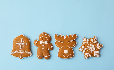 Canvas Print - Different Christmas gingerbread cookies on light blue background, flat lay. Space for text