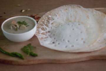 Wall Mural - Rice pancake or Hoppers locally called Appam served with Chicken and potatoes simmered in coconut milk 