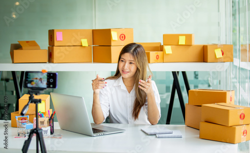 Starting Small business entrepreneur SME freelance Live chatting with customers to review online orders to pack boxes at home office,laptop,marketing, packaging, delivery, SME, e-commerce concept