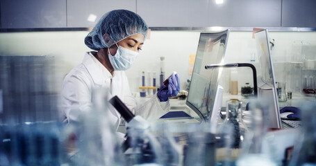 Wall Mural - asian female doctor working on biohazardous samples in laboratory. using microscope
