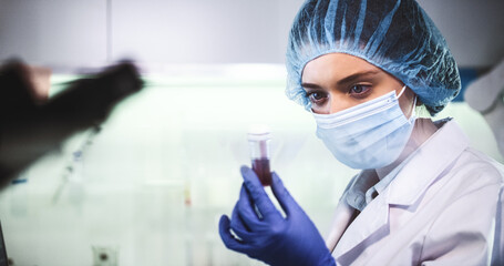 Wall Mural - female doctor working in futuristic laboratory. wearing protective workwear for biohazardous sample 