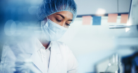 Wall Mural - asian female doctor working on biohazardous samples in laboratory. using microscope