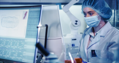 Wall Mural - young fenale doctor working in laboratory. biohazardous samples