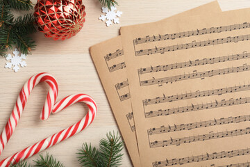 Wall Mural - Flat lay composition with Christmas music sheets on wooden background