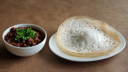 Wall Mural - Hoppers with black chickpea gravy, A South Indian breakfast delicacy