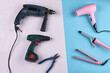 © DenisProduction.com - Tools for male and female work. Set of power drills with pliers versus hair dryer and hair straightener.