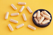 Vitamin B Complex Capsules On A Yellow Background