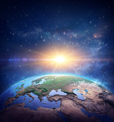 Wall Mural - surface of planet earth, space view of the world focused on europe. rising sun shining into deep spa