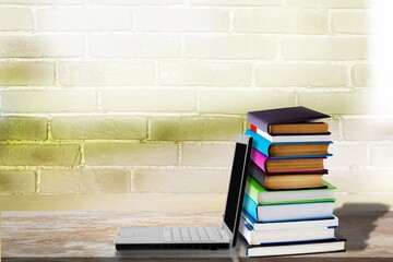 Wall Mural - Stack of books with modern laptop on table