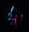 © Alejandro Campollo/Wirestock - Man in a hood showing his abs standing against a dark background