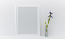 3d Render Of A Blank Frame And A Vase By A Wall