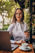 © eastwest photo - woman working on the laptop in caffe