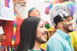 Group of people with rainbow flags and banners during Gay Pride event - Lgbt concept - Focus on transgender face