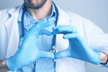 Wall Mural - Heart shaped hand in medical gloves