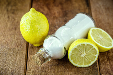 glass with baking soda and citrus fruits like lemon or orange around. Home remedy against stomach acid, anti acid