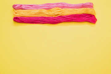 Canvas Print - Top view of colorful yarns isolated on a yellow background