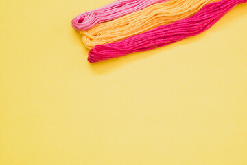 Canvas Print - Top view of colorful yarns isolated on a yellow background