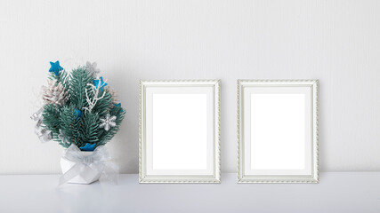 Christmas composition in a pot with two frames mockup in the white interior