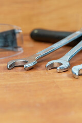 Wall Mural - three wrench closeup on a hammer, selective focus background construction