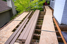 Summer Construction, Outdoor Deck Under Construction, Old Support Joists With Plywood Walkway And Manufactured Planks
