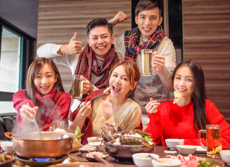 Wall Mural - happy young friends  having fun in hot pot restaurant