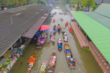 Damnoen Saduak Floating Market or Amphawa. Local people sell fruits, traditional food on boats in canal, Ratchaburi District, Thailand. Famous Asian tourist attraction destination. Festival in Asia.