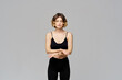 © SHOTPRIME STUDIO - Sporty woman in leggings on a gray background is engaged in fitness Copy Space