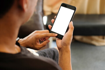 Wall Mural - cropped shot of young man relaxing on comfortable couch while holding smartphone with blank screen i