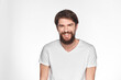 © SHOTPRIME STUDIO - Bearded man in white t-shirt gesture with hands emotions light background