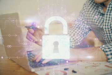 Double exposure of lock icon with man working on computer on background. Concept of network security.