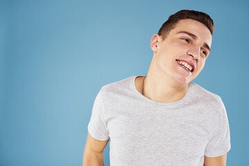 Emotional man in white t-shirt cropped view on blue background lifestyle