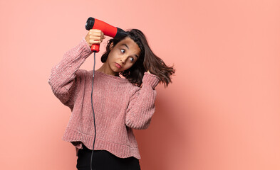 hispanic pretty woman with a hair dryer