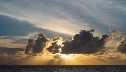 Wall Mural - abstract amazing scene of stuning colorful sunset with moving clouds background in nature and travel