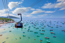 Hanging Cabin On The Phu Quoc Cable Car To Hon Thom Island Above Azure Sea. Top View Of Vietnamese Fishing Boats In The Turquoise Sea On Phu Quoc Island, Vietnam