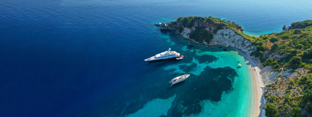Wall Mural - Aerial drone top down ultra wide photo of luxury yacht anchored in tropical exotic island turquoise sea