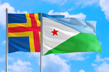 Djibouti and Aland Islands national flag waving in the windy deep blue sky. Diplomacy and international relations concept.