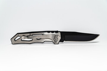 Wall Mural - Stainless steel pocketknife with a black blade isolated on a white background