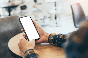 cell phone blank white screen mockup.woman hand holding texting using mobile on desk at coffee shop.background empty space for advertise.work people contact marketing business,technology